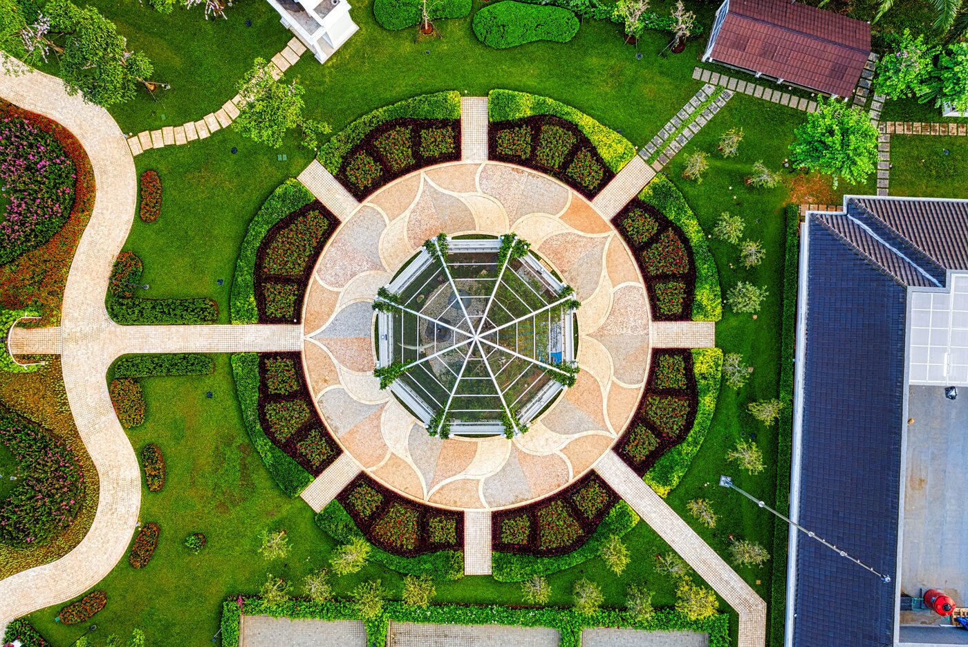 Aerial view of a circular garden and patio within a residential backyard